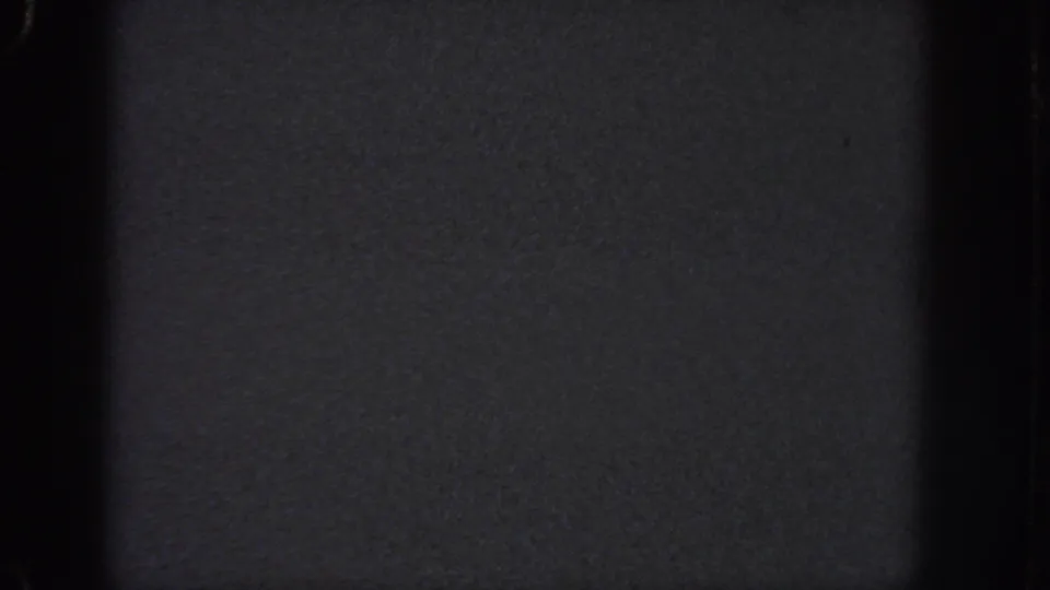 1951 Atlanta 8mm frame dominated by darkness, a central black band, soft grain, and faint exposure variation across the film.