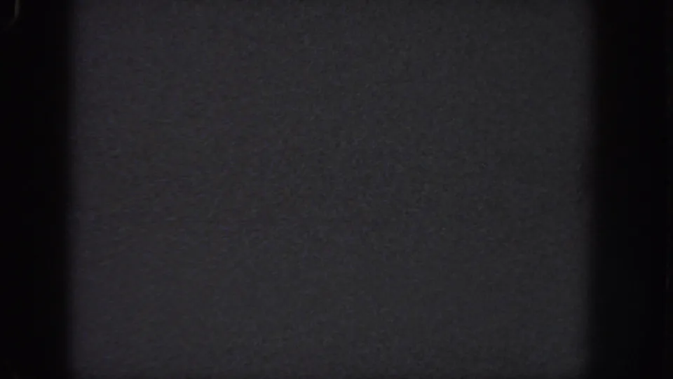 1951 Atlanta 8mm frame showing an abstract dark exposure with black vertical bands, visible grain, and no readable figures or structures.