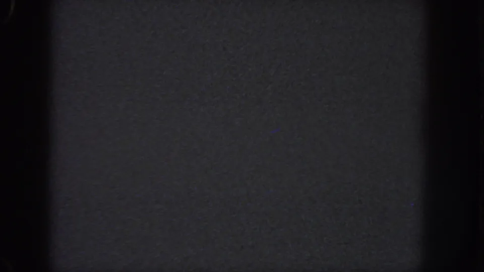 1951 Atlanta 8mm frame ending on a dark, low-exposure field with heavy grain, a black vertical band, and faint gray tonal texture.