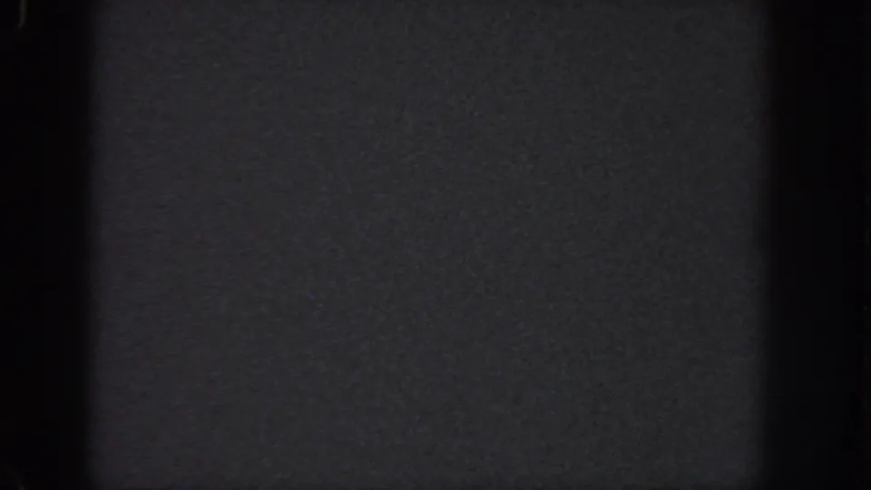 Dark 8mm home-movie frame from the 1951 Atlanta metadata, showing blank film texture, frame edges, and slight banding.