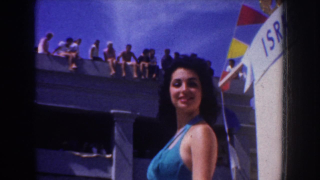 1952 California parade footage shows a woman in a turquoise swimsuit smiling beside a decorated float as spectators sit above.