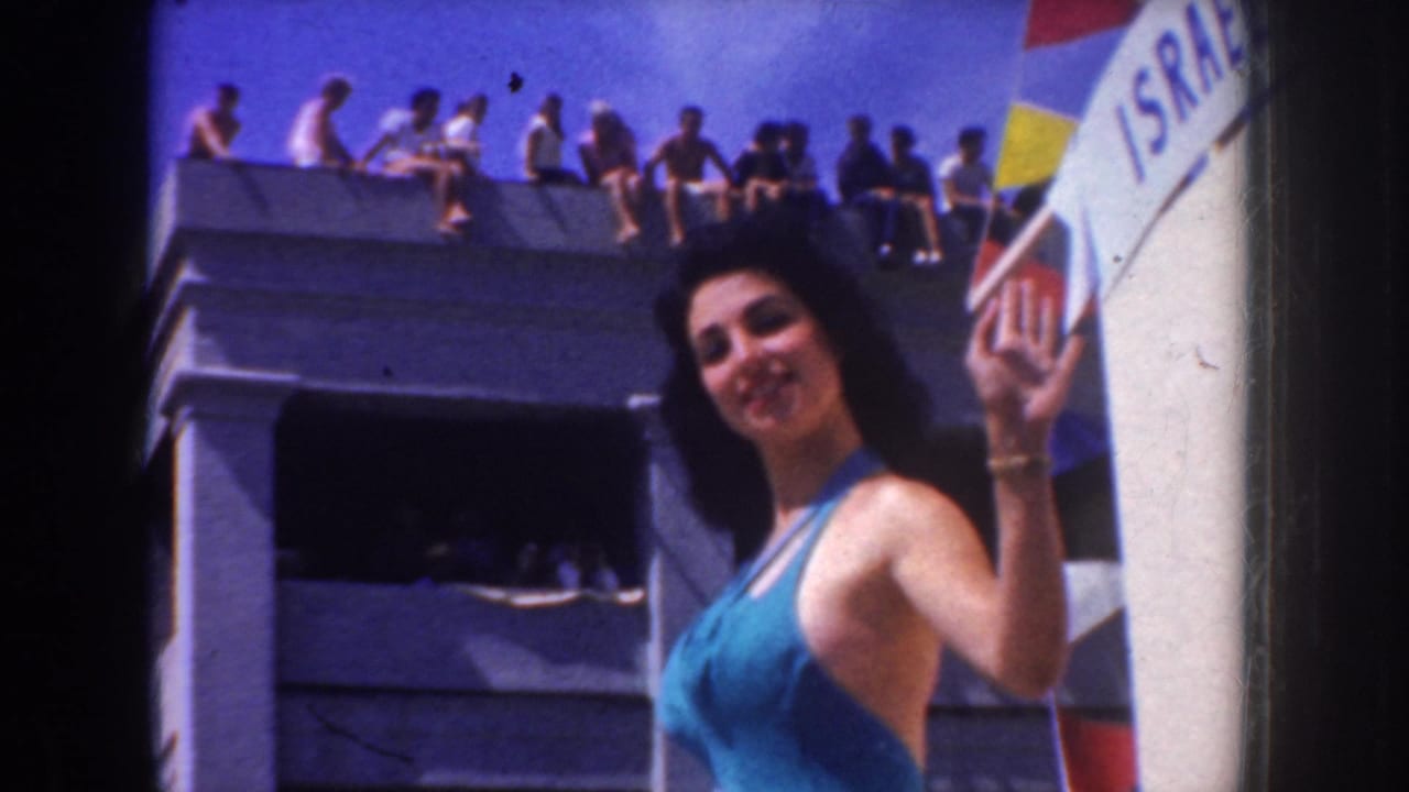 A pageant participant in a turquoise swimsuit waves from a decorated float during the California parade, with spectators above.