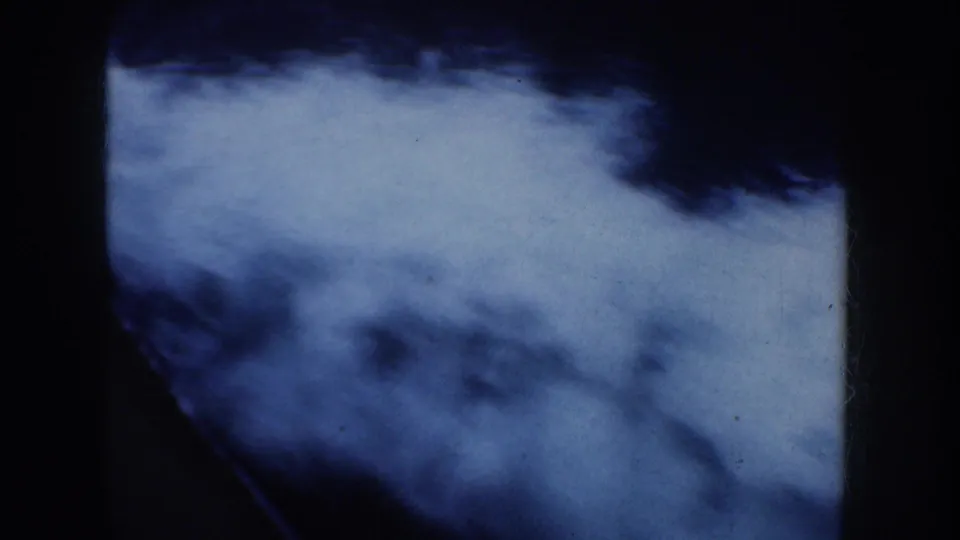 Blue-toned water fills the frame in the 8mm scan, with dark gate edges and soft, high-contrast motion blur.