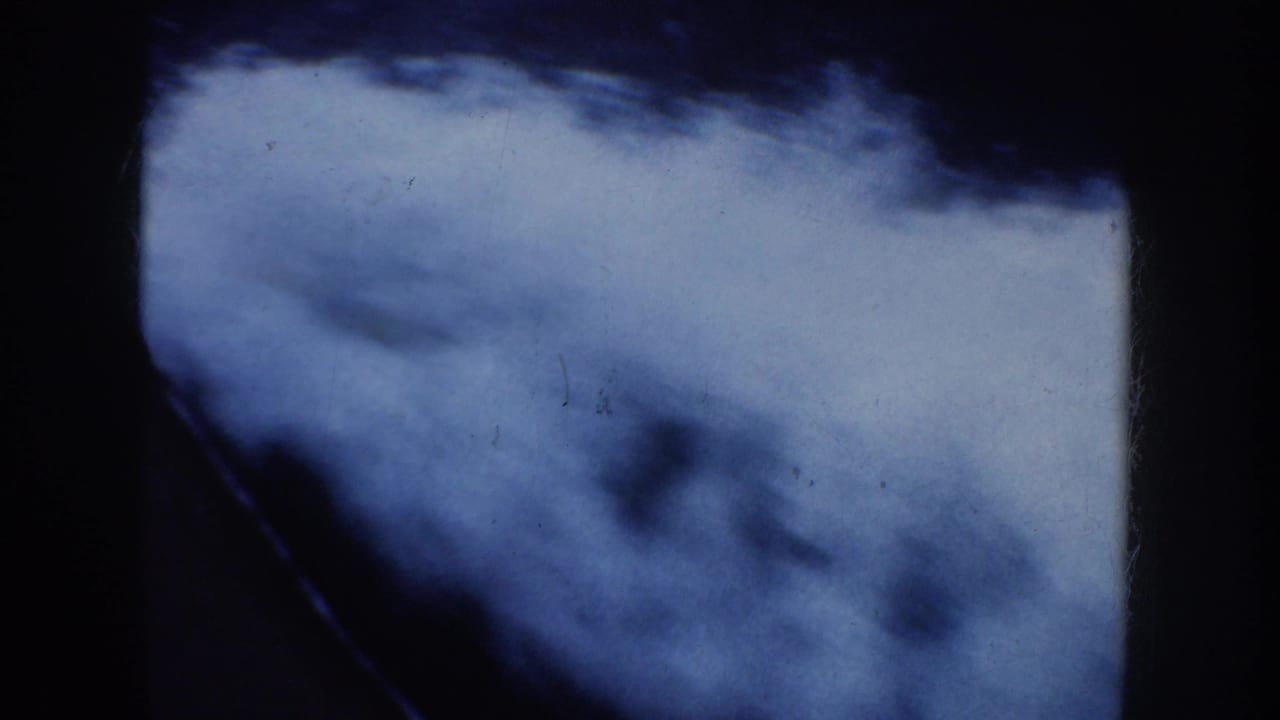 Soft 8mm frame of blue water and a dark boat edge during a California boat ride, consistent with the 1952 metadata.