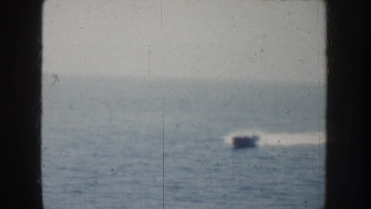 Soft 1952 California 8mm view of a fast boat moving across the ocean with a pale wake behind it.