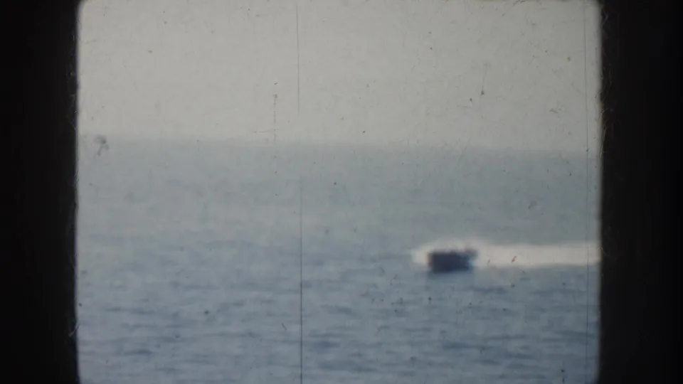 Soft 1952 California 8mm view of a fast boat moving across the ocean with a pale wake behind it.