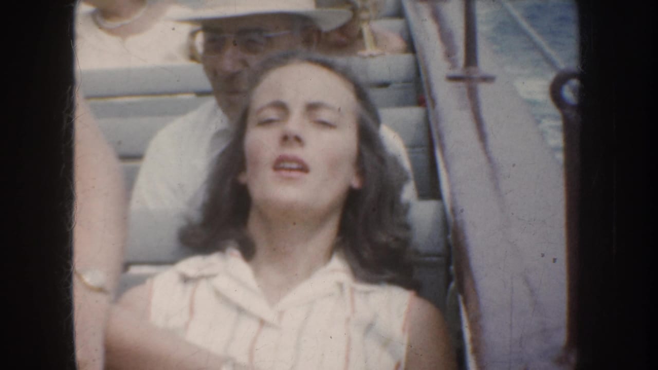 1952 California boat-ride frame showing a young woman with eyes closed and mouth slightly open, with passengers and railings behind her.