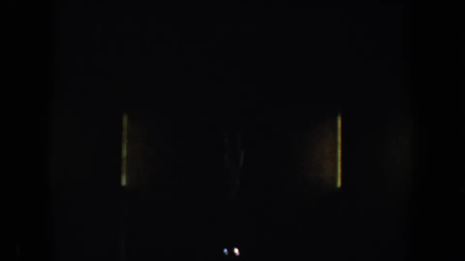 Dark 8mm frame at the end of the clip with faint light marks and minimal visible subject detail.