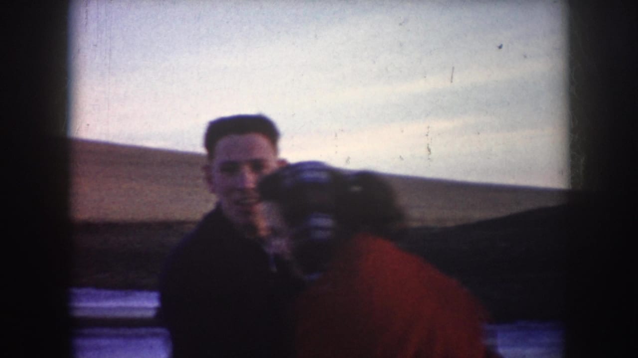 In 1953 North Dakota home-movie footage, a couple embraces on a frozen lake under a pale winter sky.