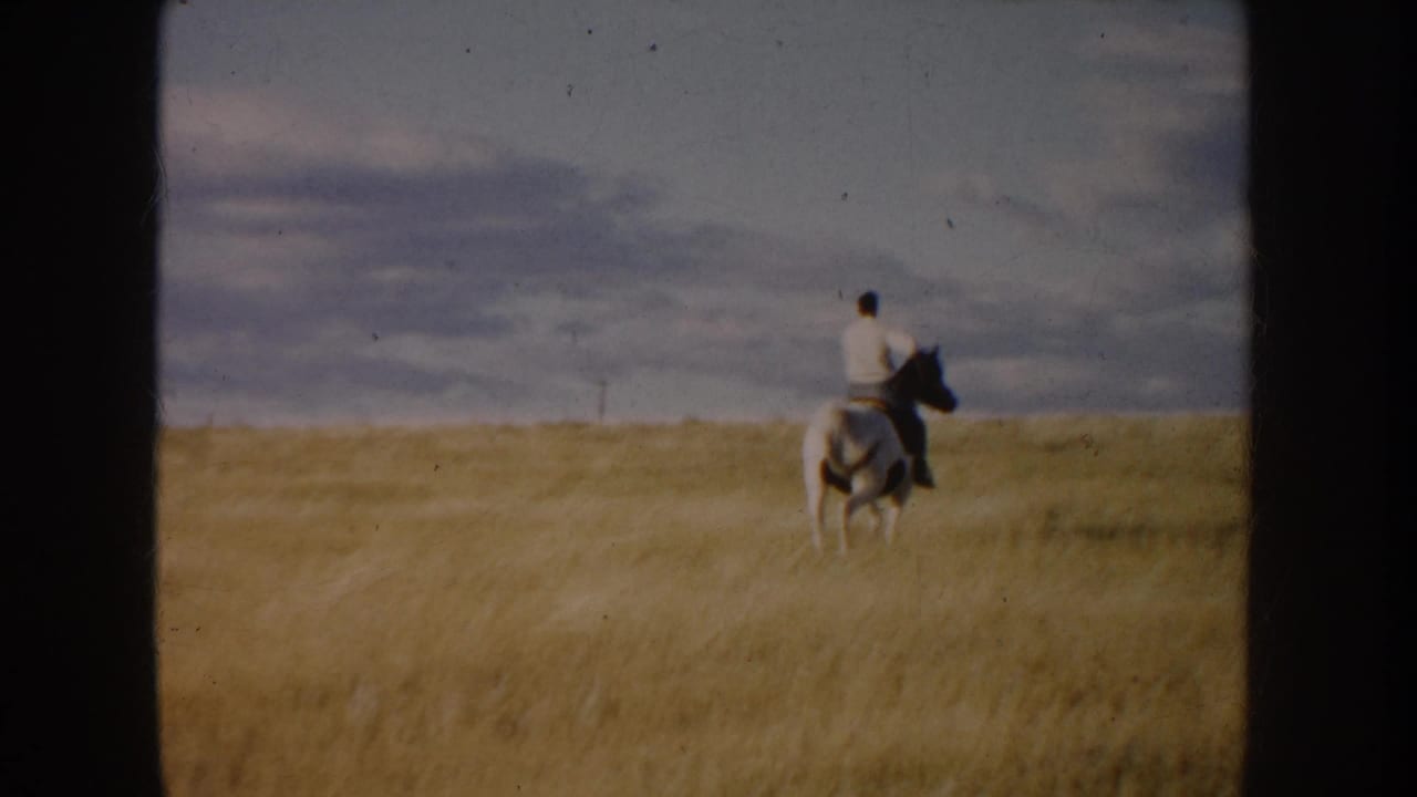 The rider continues away through South Dakota grassland, with the horse small against the open 1953 landscape.