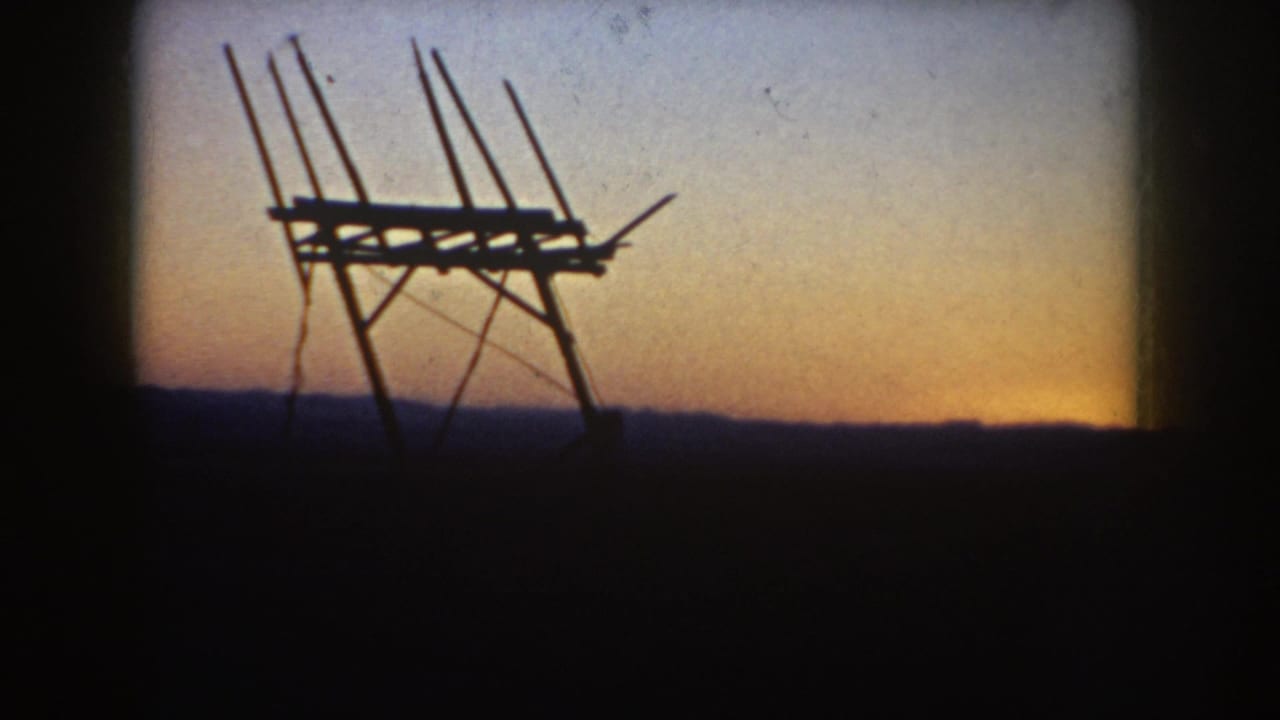 Antenna-like structure remains silhouetted as the sunset glow lowers near the horizon.