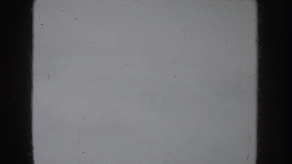 The final contact-sheet cell appears mostly blank gray film, showing dust, scratches, and dark gate edges rather than a clear subject.