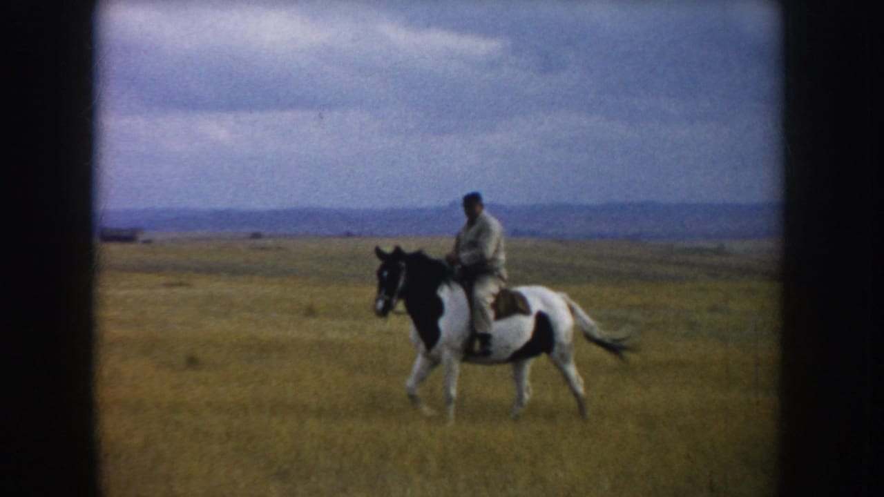 A closer side view shows a man in light clothing riding a black-and-white pinto horse across the South Dakota prairie.