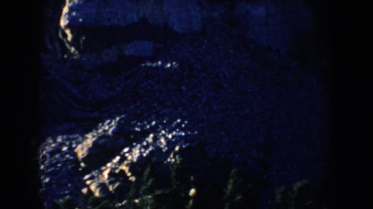 1953 South Dakota 8mm close view of Mount Rushmore, with the carved heads rendered in deep shadow and edge light.