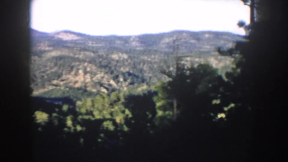 1953 South Dakota home-movie view of wooded hills and mountain ridges near the Mount Rushmore area.
