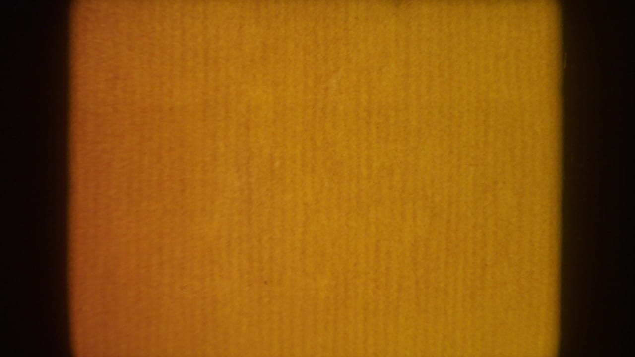 Amber 8mm frame with vertical dark edges and no clear people visible.