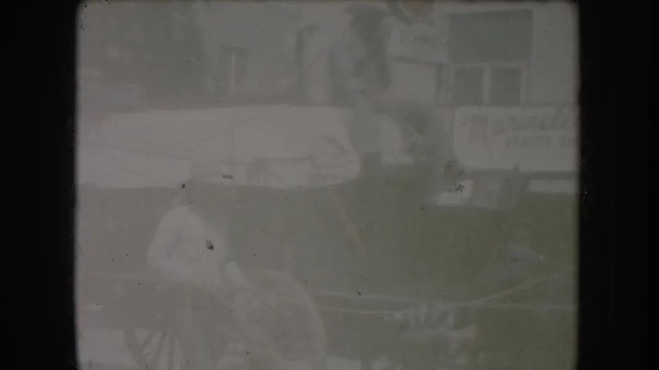 Final 8mm frame showing extreme dye loss and near-total white-out consistent with end-of-reel film damage; only faint ghosted shapes remain visible.