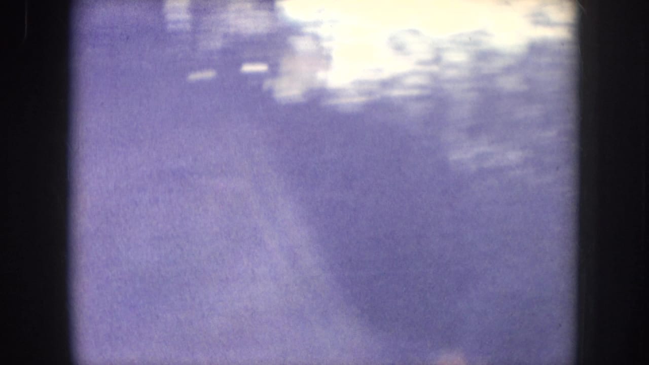 Large smoke or haze column filling the frame against a bright overexposed area; possible foliage silhouettes at edges.