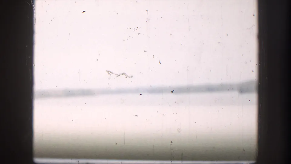 Overexposed opening frame from a 1958 8mm home movie — possibly a title card or a bright outdoor shot — with film dust and barely visible horizontal lines.