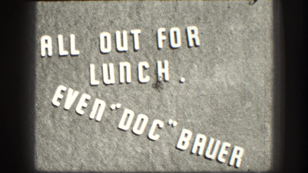 Close-up of a humorous 1950s business sign in white stenciled lettering on a gray concrete or stone surface, Kansas, circa 1958.