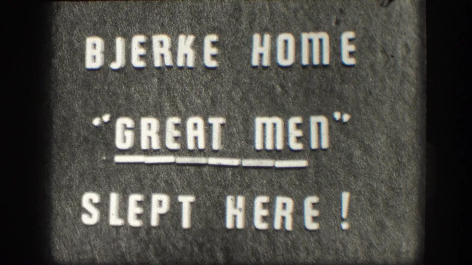 Final frame of 1958 8mm intertitle sequence: 'BJERKE HOME / GREAT MEN SLEPT HERE!' white capitals on gray textured background, double underline beneath GREAT MEN.