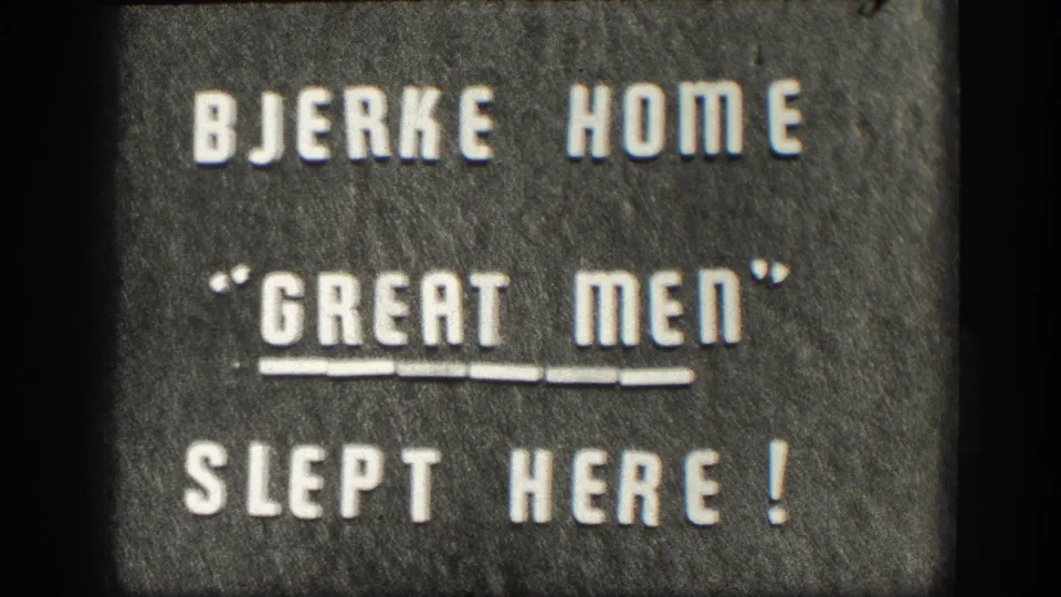 1950s 8mm home movie intertitle: white press-type letters on a dark felt-like board reading BJERKE HOME / 'GREAT MEN' / SLEPT HERE!, Kansas, USA.