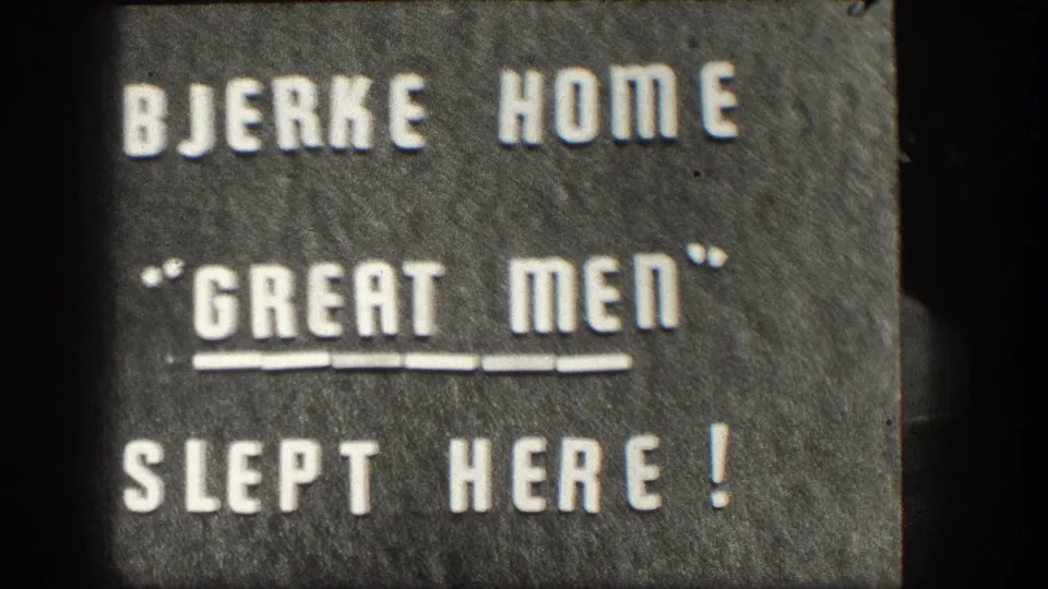 Held 8mm intertitle frame: white press-type letters on dark felt-like board reading BJERKE HOME / 'GREAT MEN' / SLEPT HERE!, mid-century Kansas home movie.