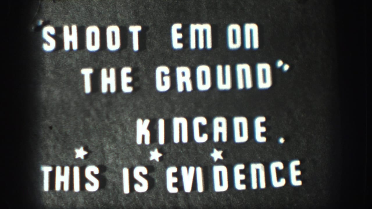 Hand-lettered home-movie title card: 'SHOOT EM ON THE GROUND / KINCADE / THIS IS EVIDENCE'; consistent with 1950s amateur film titling.