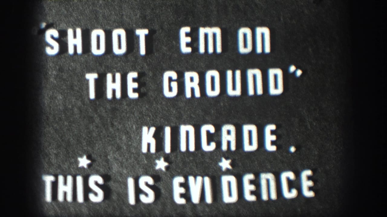 1958 Kansas 8mm home movie title card; white stencil letters on dark board read SHOOT EM ON THE GROUND, KINCADE, THIS IS EVIDENCE with three small star ornaments