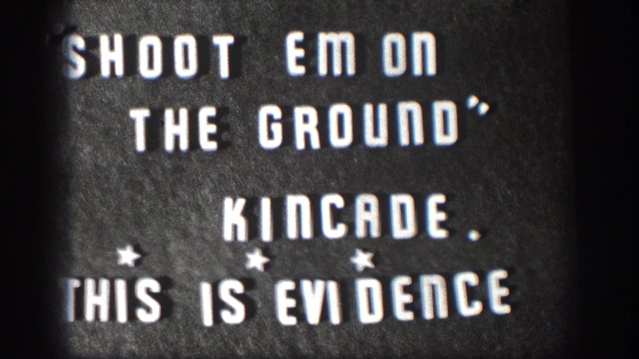 1958 Kansas 8mm home movie title card; white stencil letters read SHOOT EM ON THE GROUND, KINCADE, THIS IS EVIDENCE with star ornaments and film-edge vignette