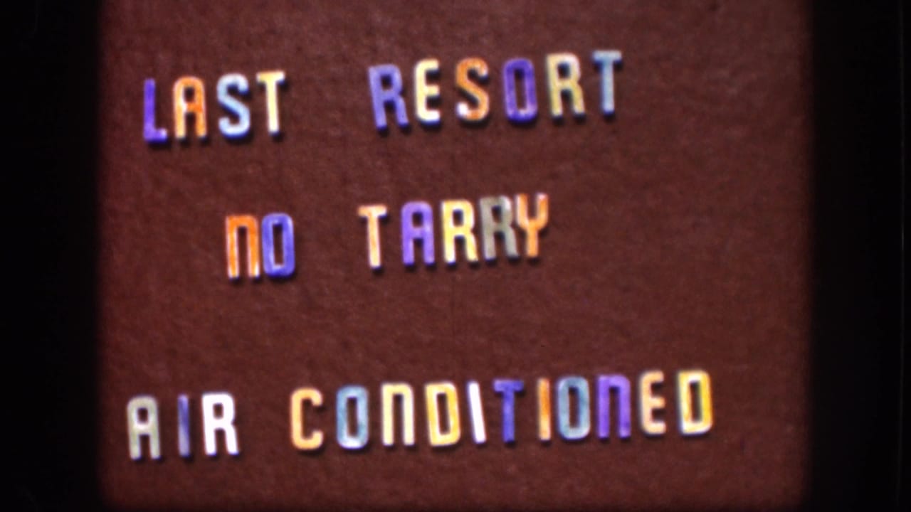 Close-up of a dark brownish-red changeable letter board with multicolored plastic letters reading LAST RESORT, NO TARRY, AIR CONDITIONED.