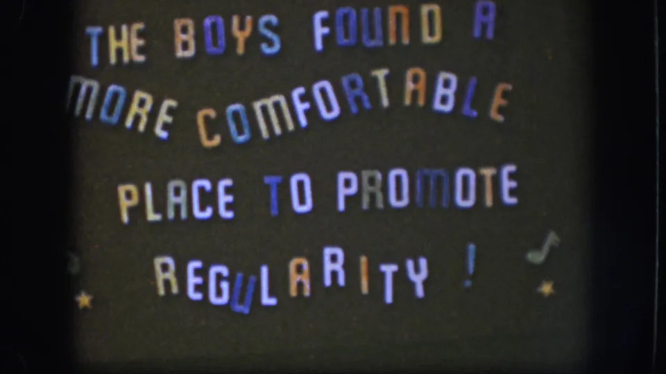 8mm title card circa 1958 Kansas, showing multicolored lettered phrase with musical note and star embellishments; consistent with first frame.