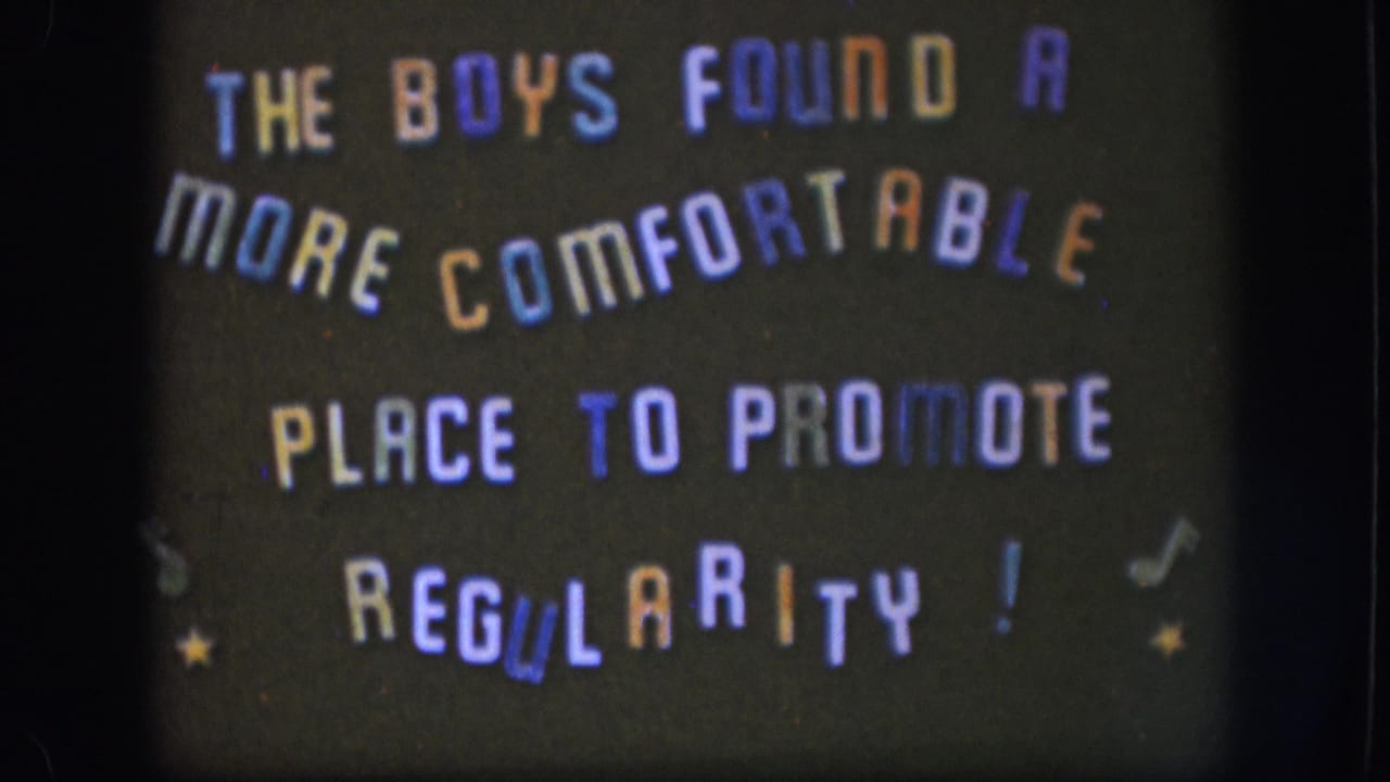 Sustained view of the 1958 home-movie title card; background appears slightly darker, with the same multi-colored stencil lettering and decorative star elements.