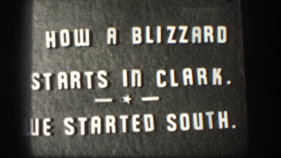 A second exposure of the 8mm title card 'HOW A BLIZZARD STARTS IN CLARK. — ★ — WE STARTED SOUTH.' held on screen, consistent with home-movie chapter-card conventions circa 1958.