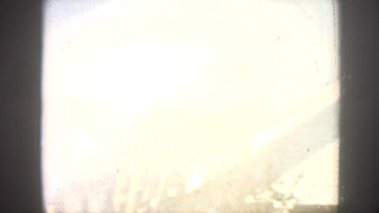 Severely overexposed frame, nearly all white with faint edge detail at lower right.