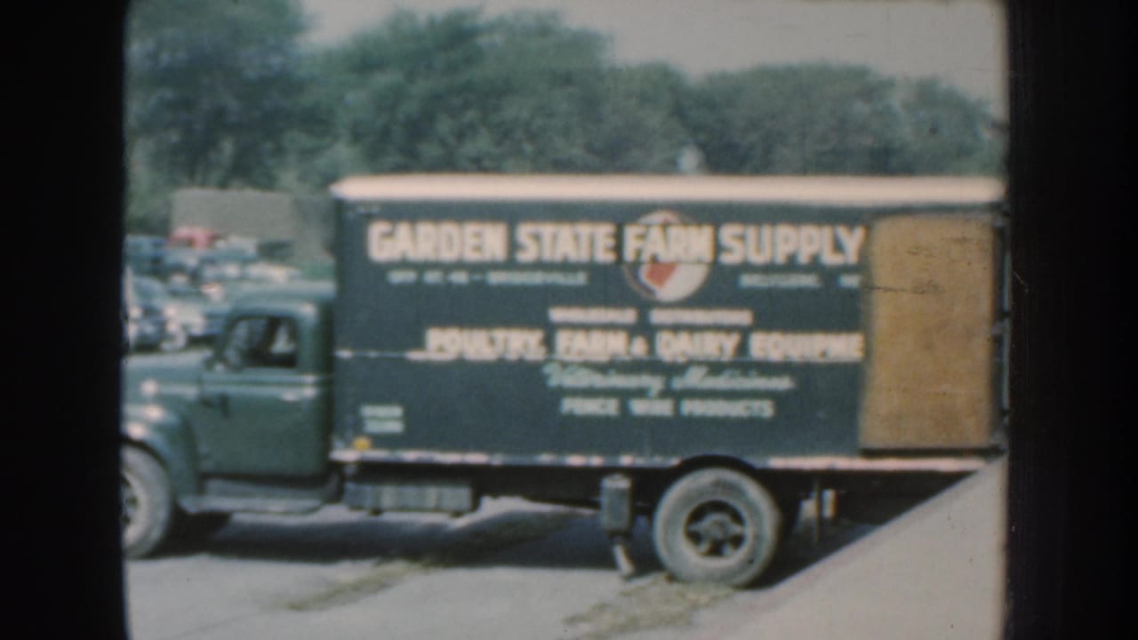 Side view of the Garden State Farm Supply truck in the 1959 Nebraska footage, with farm and poultry equipment text visible.