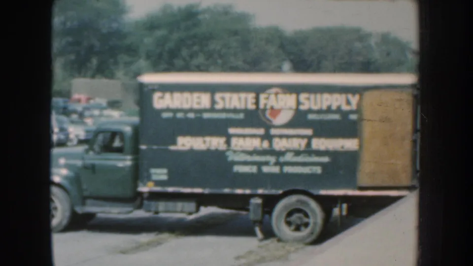 Side view of the Garden State Farm Supply truck in the 1959 Nebraska footage, with farm and poultry equipment text visible.