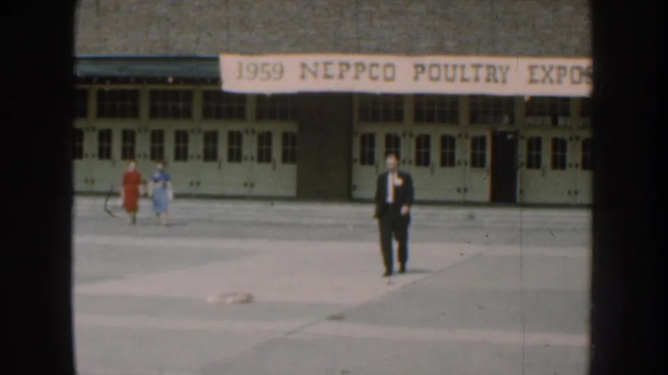 A wider 1959 Nebraska frame shows the NEPPCO Poultry Expo banner, two women in dresses, and a suited man on the paved grounds.