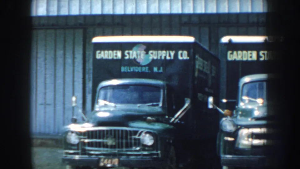 1959 Nebraska frame showing an older truck in front with a Garden State Supply Co vehicle partly visible behind it at the service site.