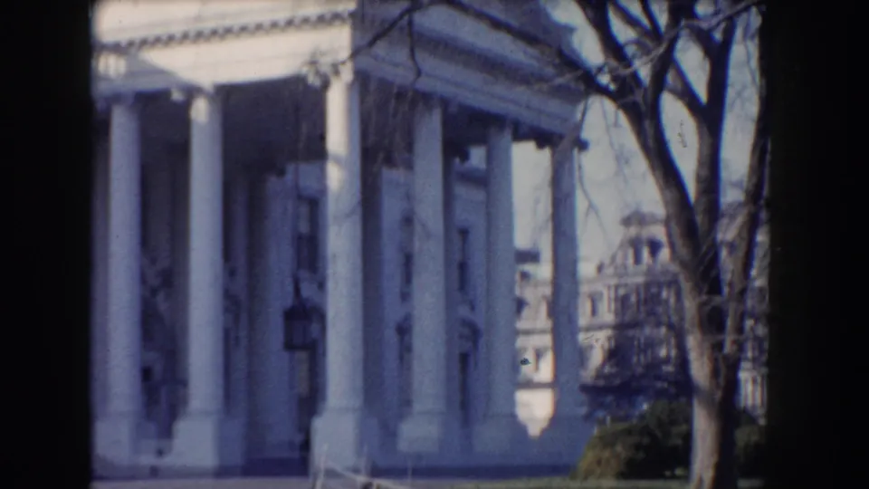 The clip ends on an angled Washington, DC view of a white neoclassical facade, trees, lawn, and nearby architecture.