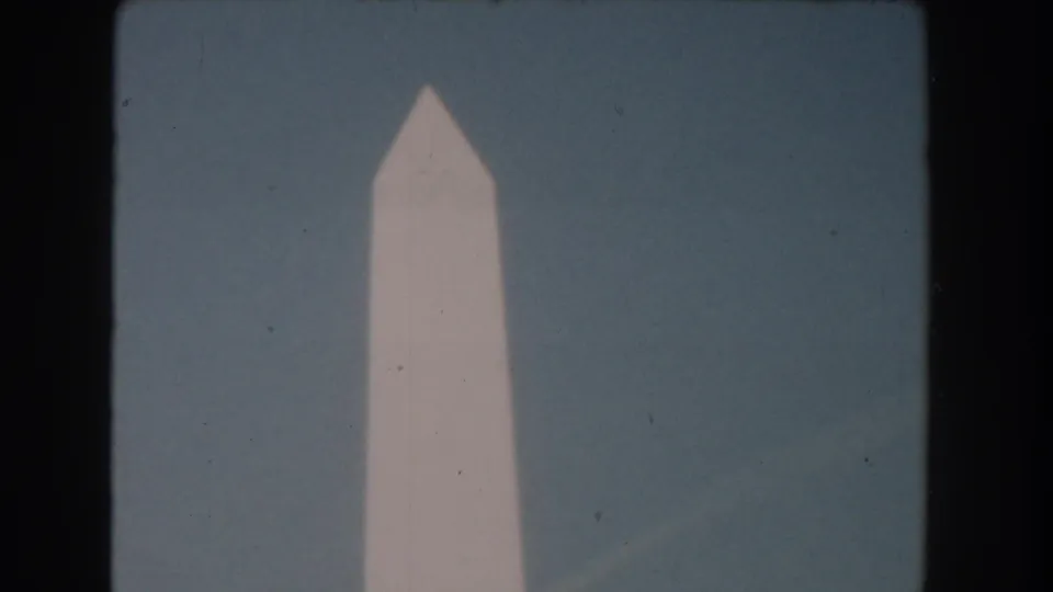 Washington Monument in Washington, DC, filmed in soft 8mm focus against a pale blue sky in 1960.