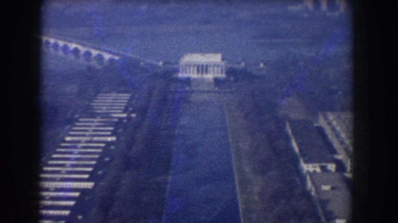 1960 Washington, DC aerial frame showing the Lincoln Memorial, Reflecting Pool, Arlington Memorial Bridge, roads, and surrounding parkland.