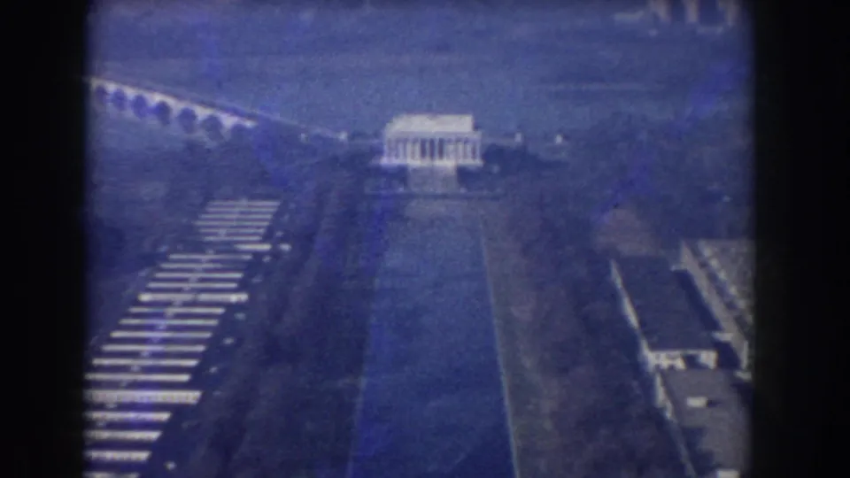 1960 Washington, DC aerial frame showing the Lincoln Memorial, Reflecting Pool, Arlington Memorial Bridge, roads, and surrounding parkland.