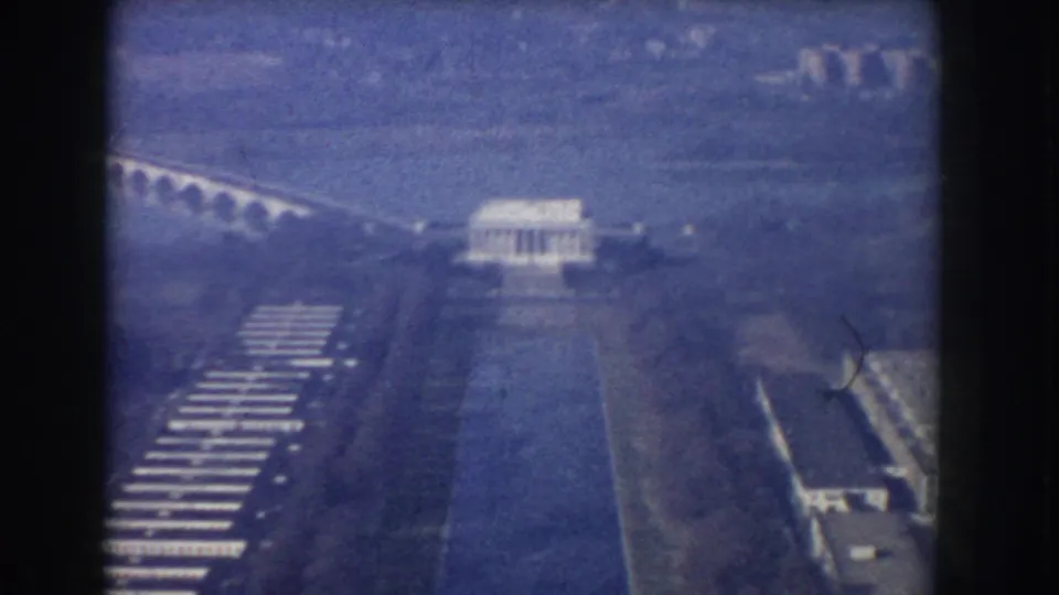 1960 Washington, DC aerial view showing the Lincoln Memorial centered near the Reflecting Pool, with Arlington Memorial Bridge and parkland around it.