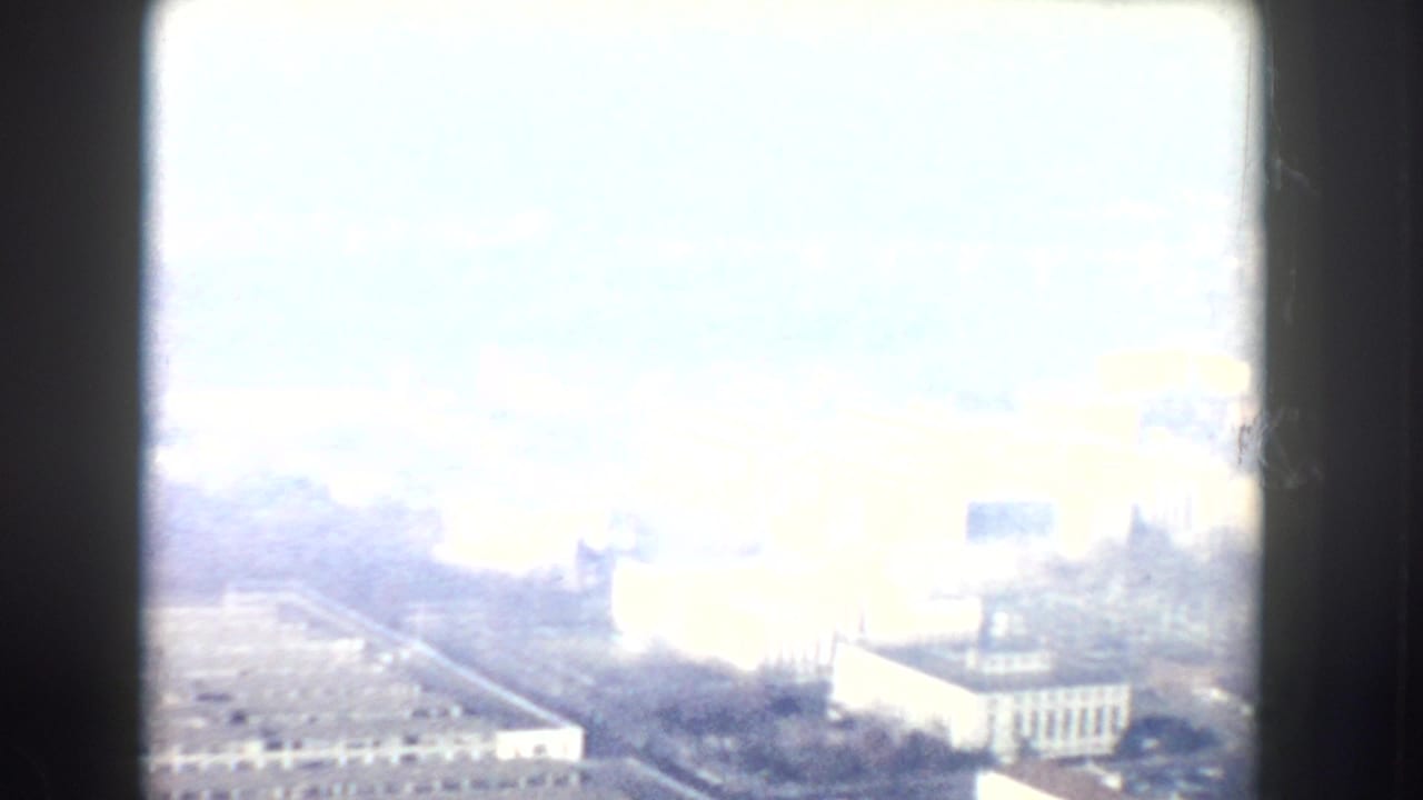 Overexposed aerial view of roads and large civic buildings.