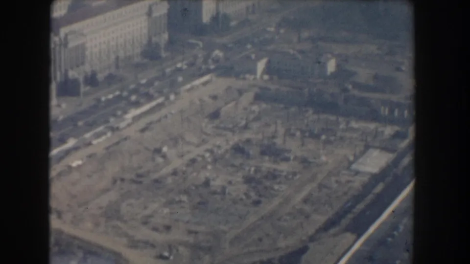 1960 Washington, DC aerial view of a broad construction excavation, surrounding roads, traffic, and nearby monumental buildings.