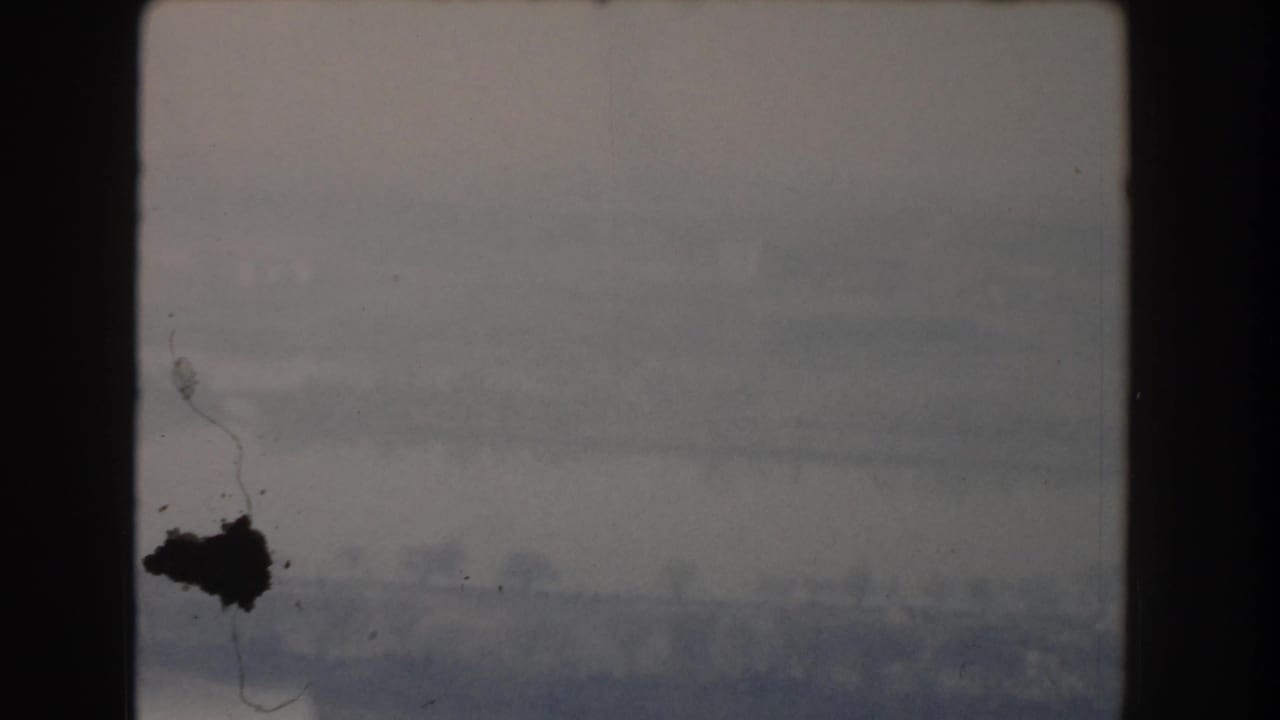 Hazy overcast sky with film border and dark emulsion mark.