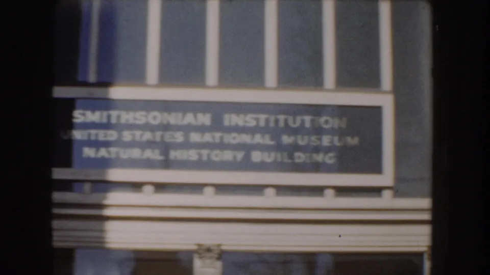 A close view shows the Smithsonian Institution sign for the United States National Museum Natural History Building.