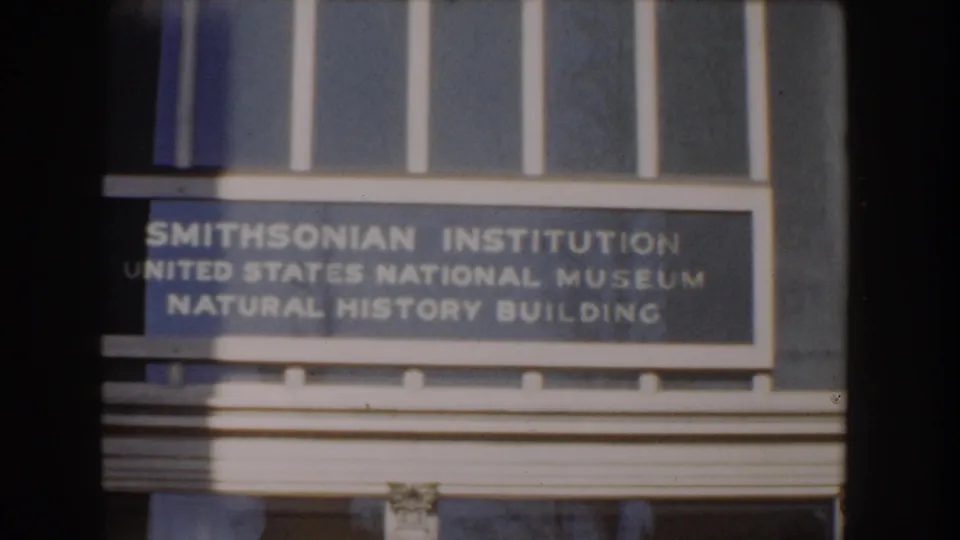 The camera holds on the Smithsonian Institution sign naming the United States National Museum Natural History Building.