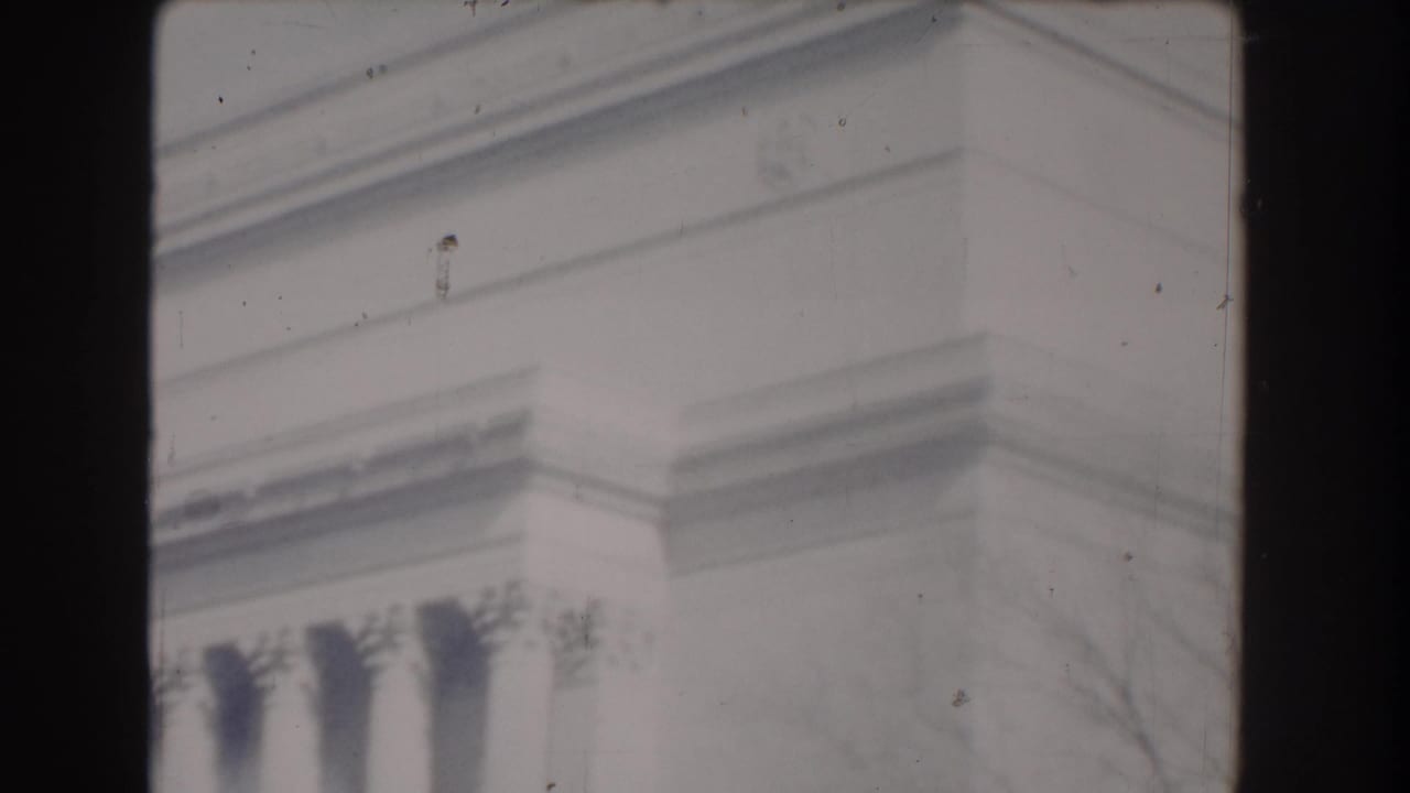 Close architectural detail of a classical stone monument with dark 8mm film borders.
